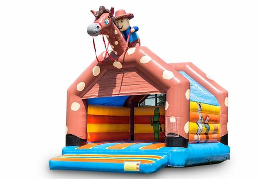 Duży dmuchany zamek do skakania z dachem w kowbojskim stylu do kupienia dla dzieci. Dostępne w JB Dmuchańce Polska online